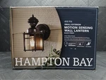 Hampton Bay 9.5IN 1-LIGHT Farmhouse Motion Sensing Outdoor Wall Lantern. Fixed Price $30.99.