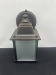 Hampton Bay 1-LIGHT Bronze Outdoor Dusk-to-dawn Wall-mount Lantern Sconce. Fixed Price $55.00.