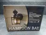 Hampton Bay 9.5IN 1-LIGHT Farmhouse Motion Sensing Outdoor Wall Lantern. Fixed Price $26.99.