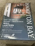 Hampton Bay Drackert 1-LIGHT Black Outdoor Wall Lantern Sconce Seedy Glass. Fixed Price $49.99.